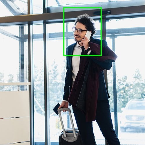 AI facial recognition interface identifying a person in a hotel lobby.