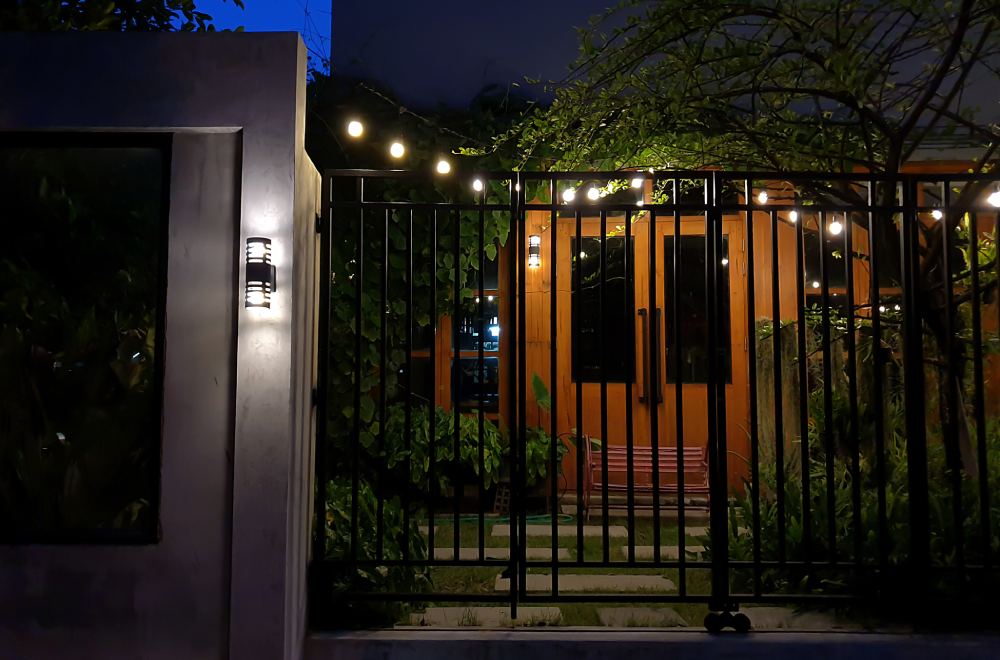 House at night with a gate in front.