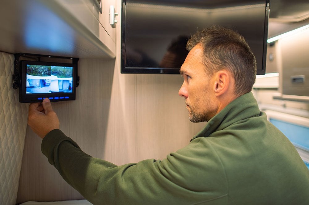 Person looking at security screen inside an RV