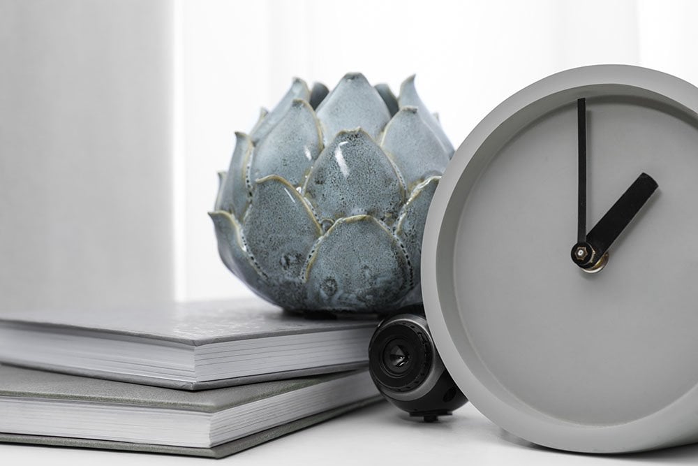A security camera hidden beside a clock